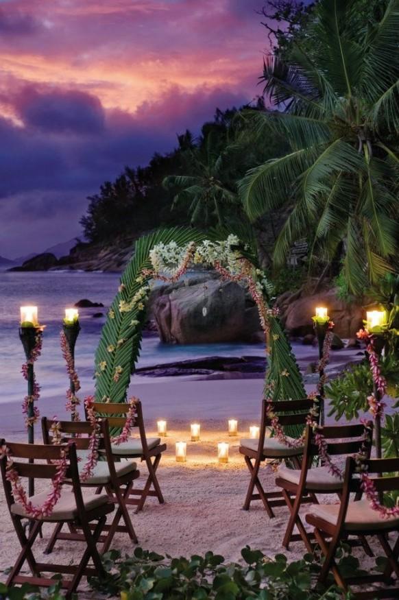 wedding photo - Wedding venue decorated with palm leaves and candles