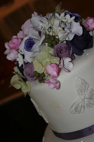 Wedding - Close Up Of Three Tier Cream And Purple Wedding Cake