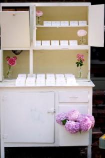 wedding photo - White wedding cabinets to display seating arrangements