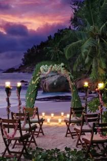 wedding photo -  Wedding venue decorated with palm leaves and candles