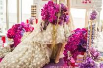 wedding photo - Radiant pink and purple colored orchids on the wedding aisle.